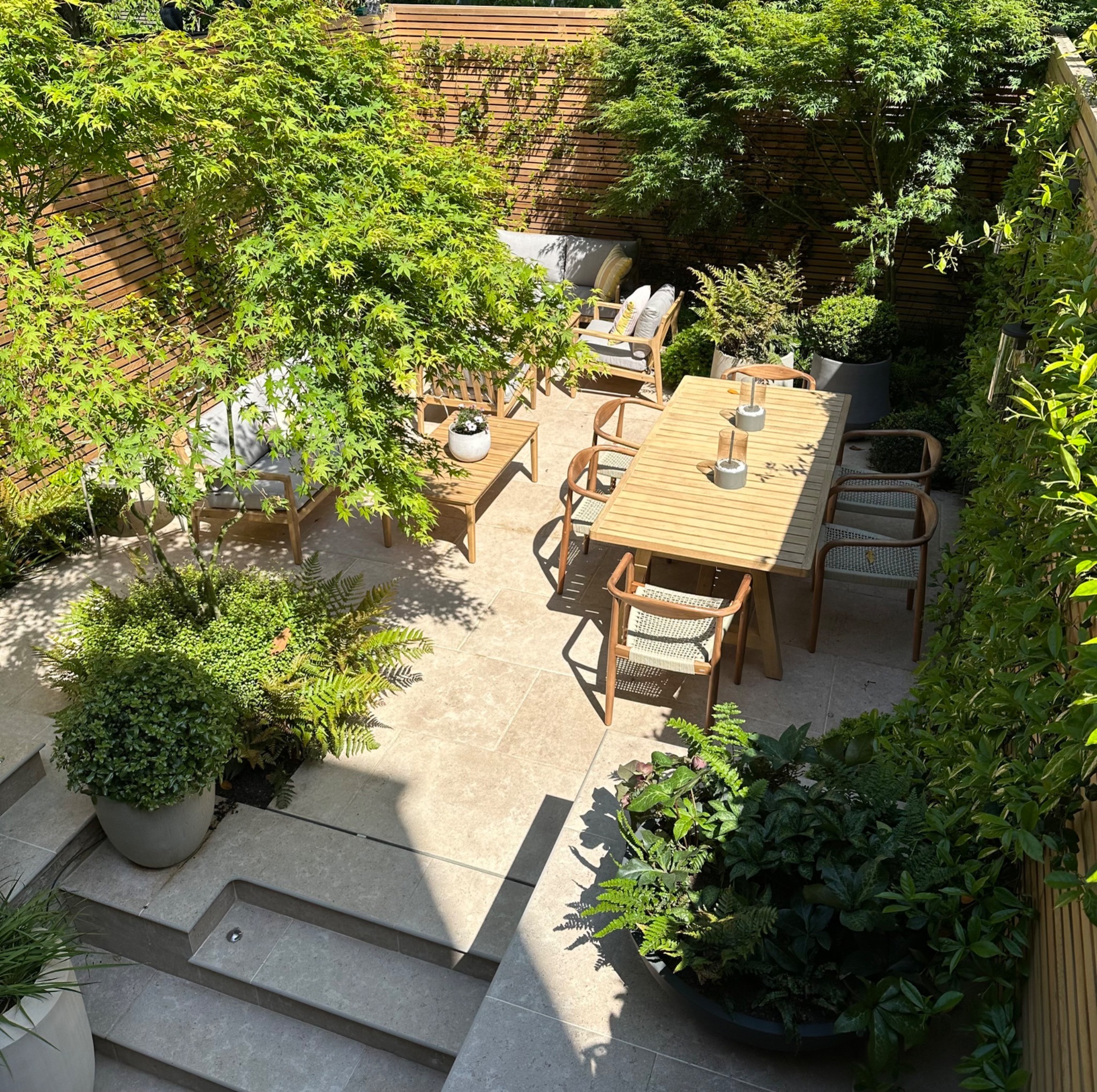 Established garden with planting, steps and an outdoor dining terrace